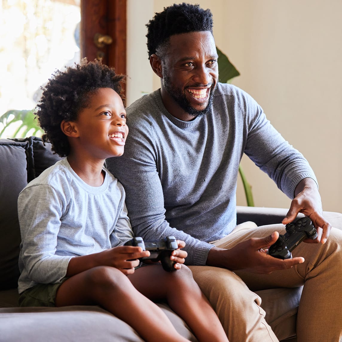 father and son playing video games