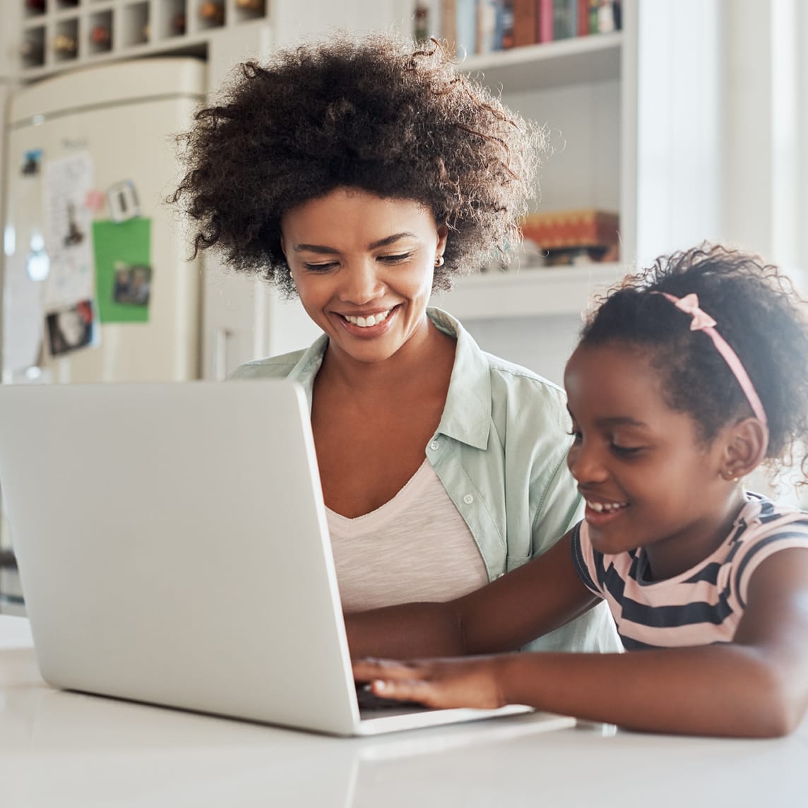 mother and daughter using a laptop